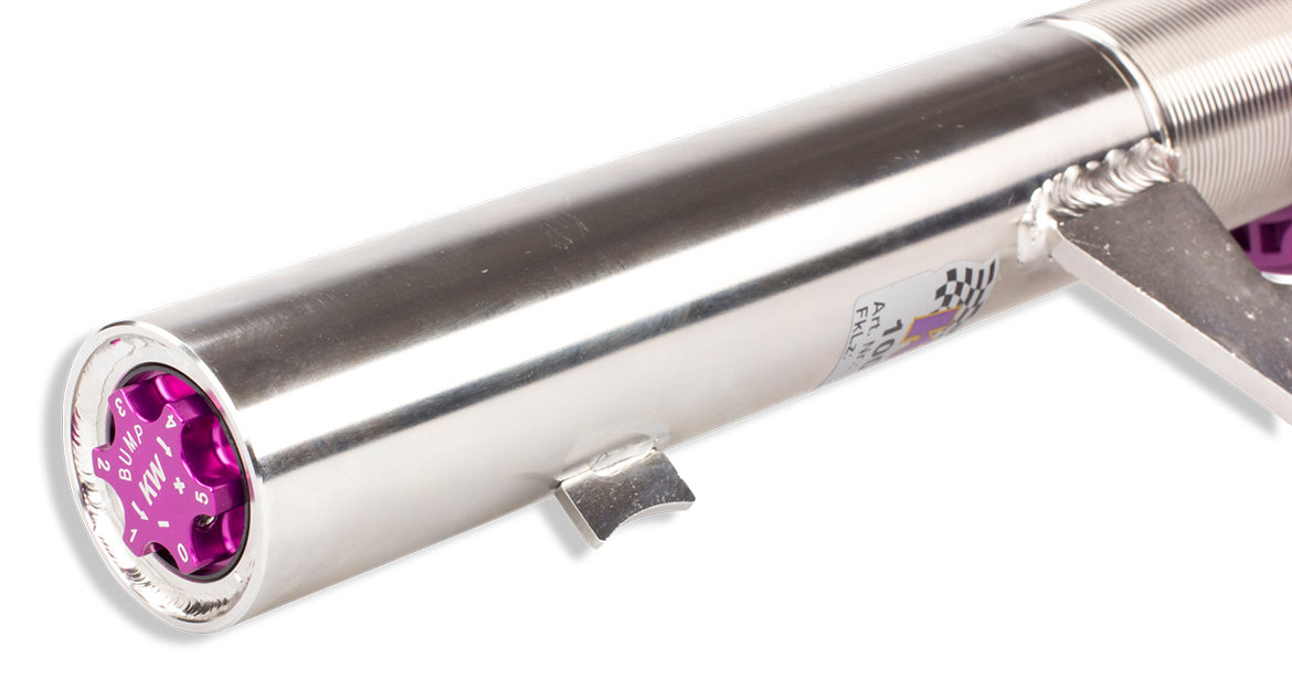 Integrated in the damper housing and the strut ist he purple compression adjuster wheel. Compression adjustment range are 12 clicks. 